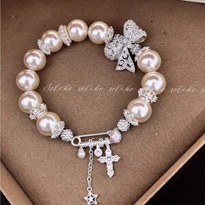 Classic Pearl Charm Bracelet with Crystal Bow and Cross